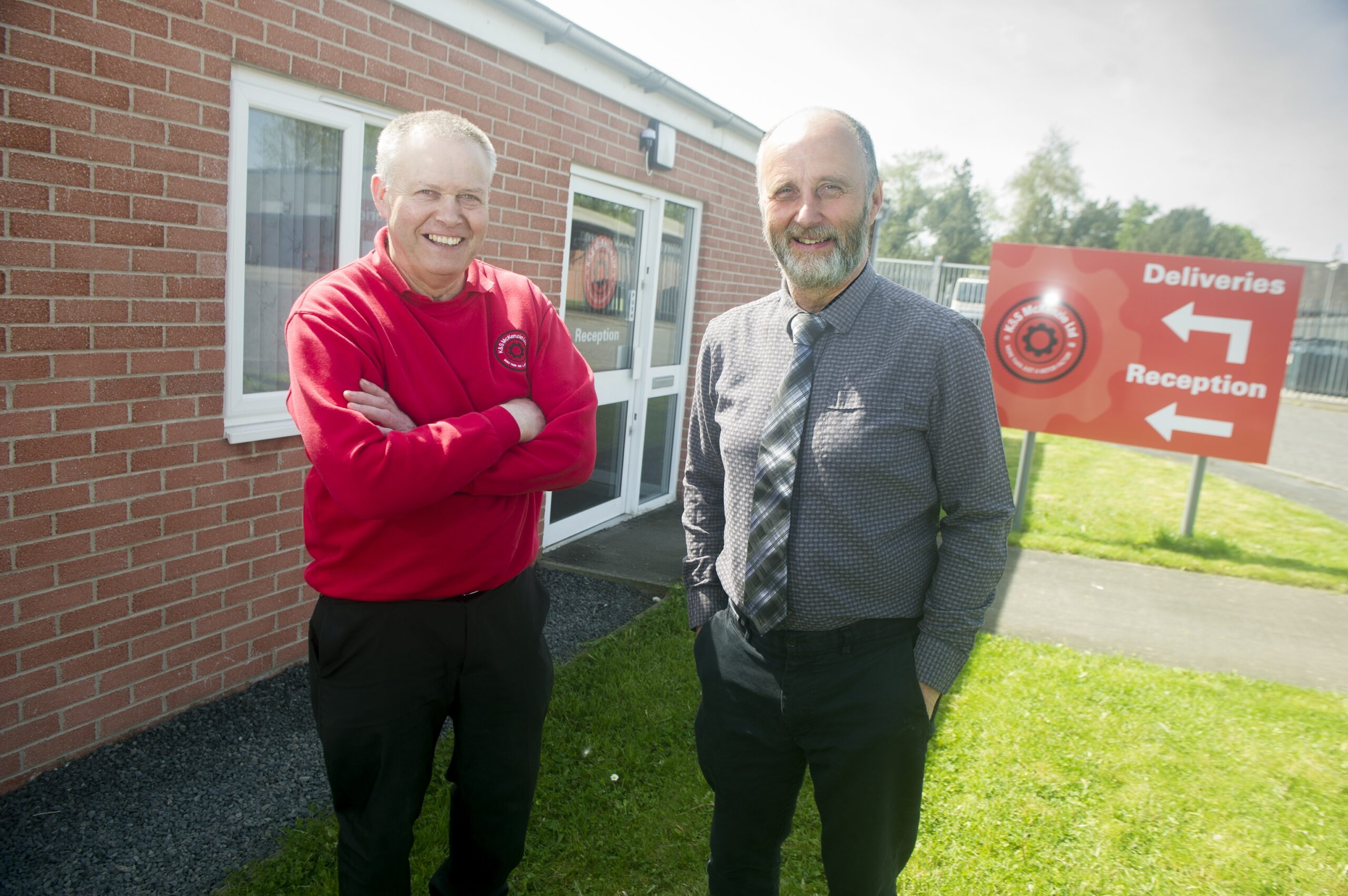 Stuart and Alastair McKenzie stood outside the front of the Distribution Centre